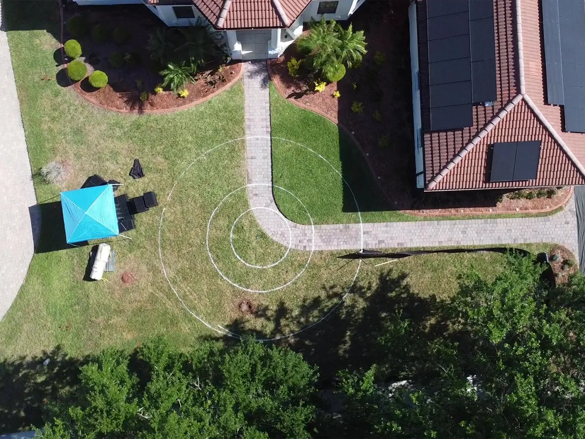 Aerial view of a marked circular area in a residential lawn for future landscaping project